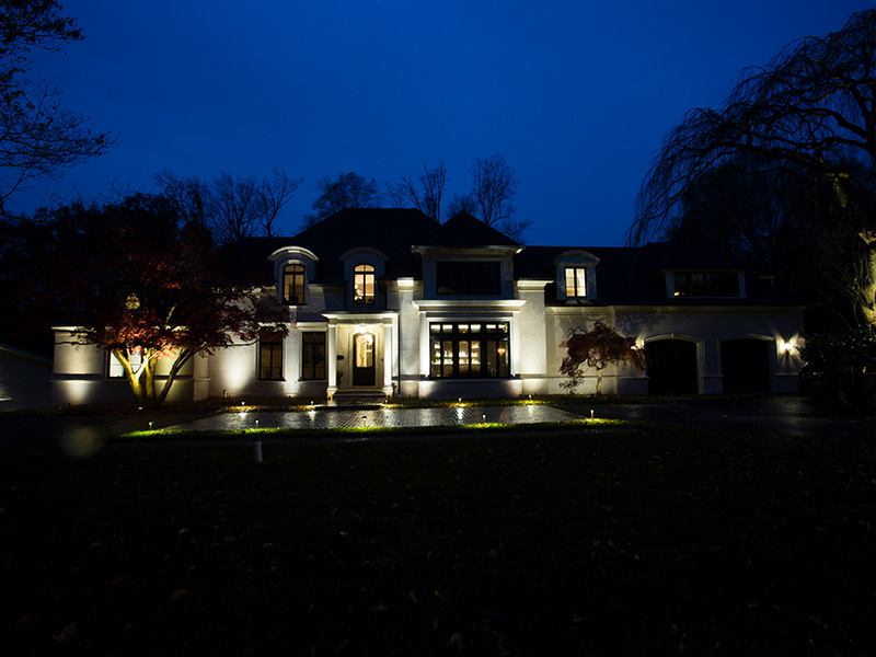 view of house at night with lights