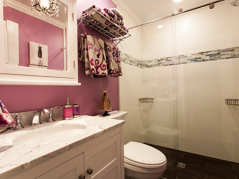 bathroom with pink wall and marble counter top