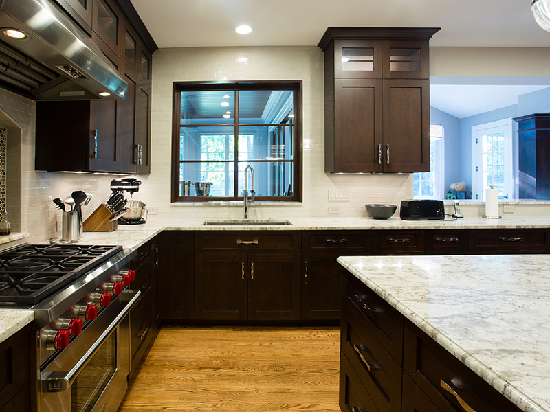 dark stained cabinets with marble counter tops