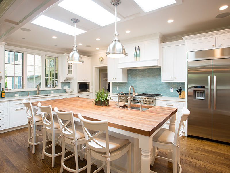 white kitchen island with chairs
